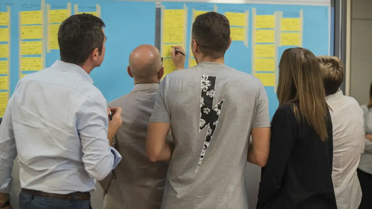 A project team reviewing a wall of sticky notes mapping a complex process